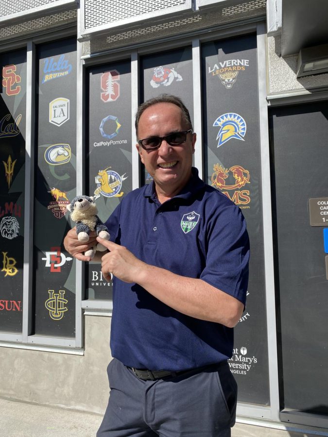Mr. Duran posing with the Wolfpack Times mascot: Durazno.