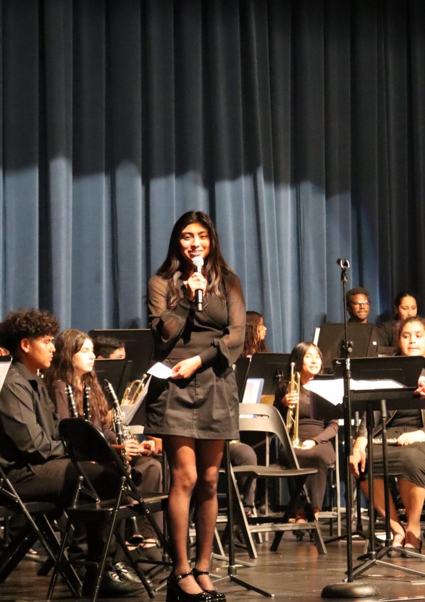 Brianna Penaloza speaking at the music concert on December 6th before the performance commenced.