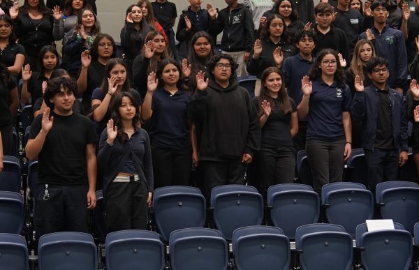 Taking an oath - Judge E. Carlos Dominguez swears in MACES student service clubs.