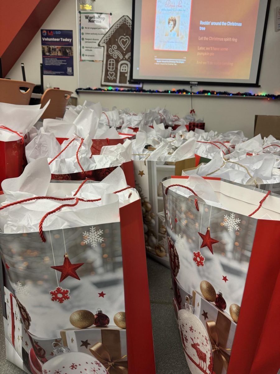 THE RED SEA - On the other side of the Parent Center, students filled bright red gift bags with color pages, race cards, and festive surprises. The bags lined the floor, ready to be sent off in the back of a truck to children in Vernon and all the way down to Mexico.