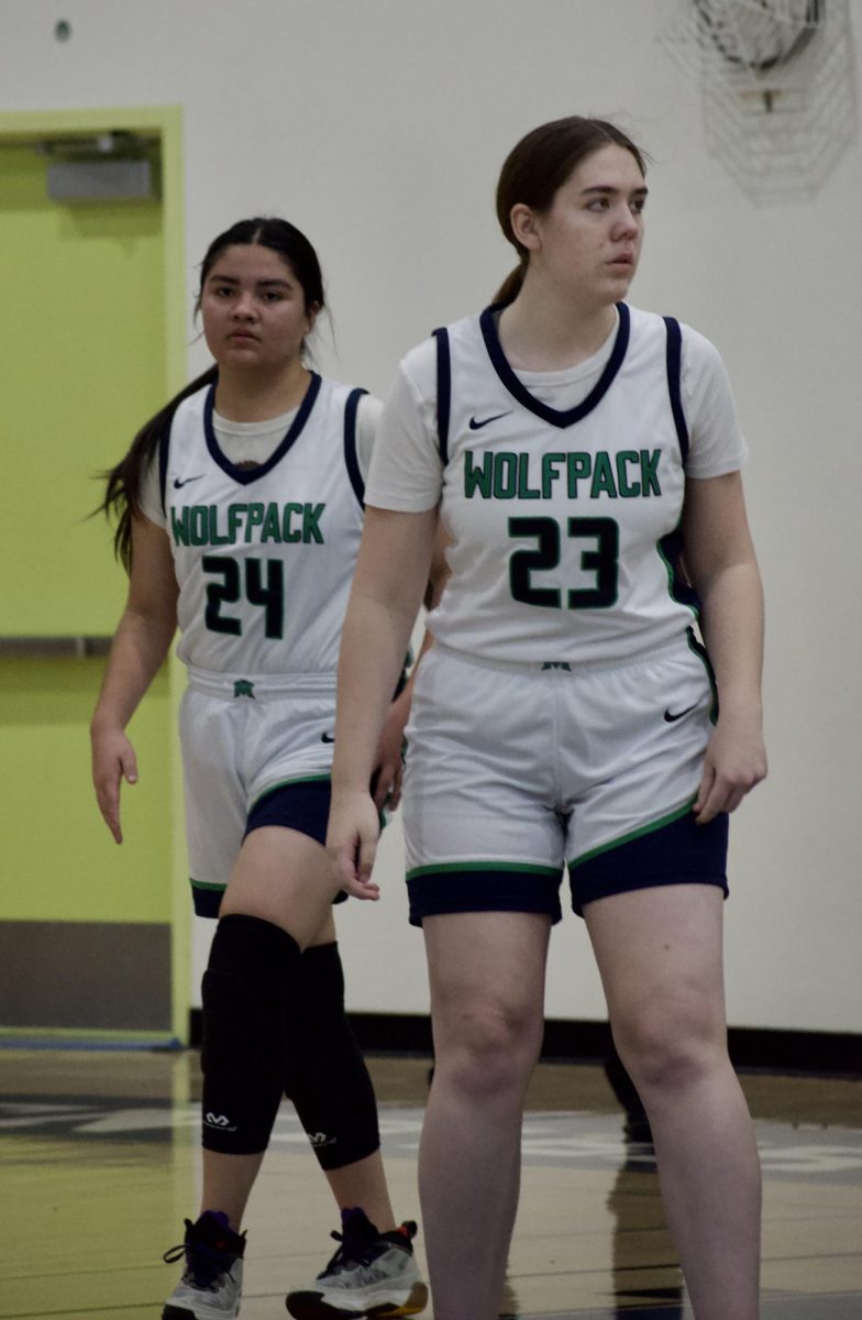 DYNAMIC DUO DETERMINED - Varsity lady pack basketball players, Samantha Ortiz [left] and Ellen Kendall [right], getting set on defense preparing for what's to come to ensure they remain victorious.