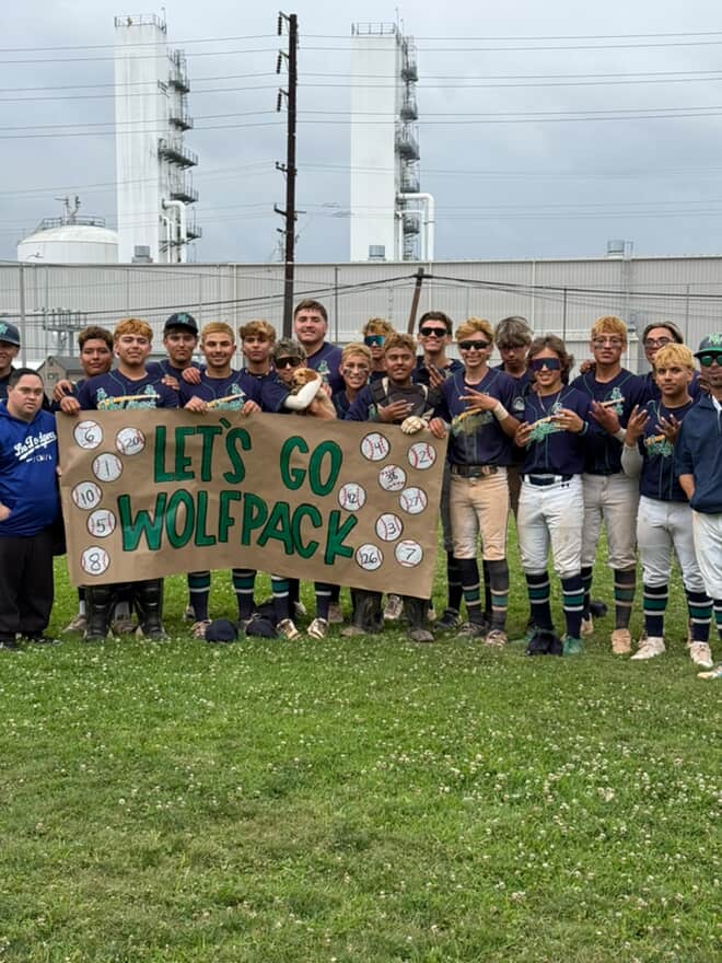 Boys Wolfpack baseball posing for a picture after their win over Monroe High School by a score of 7-1.