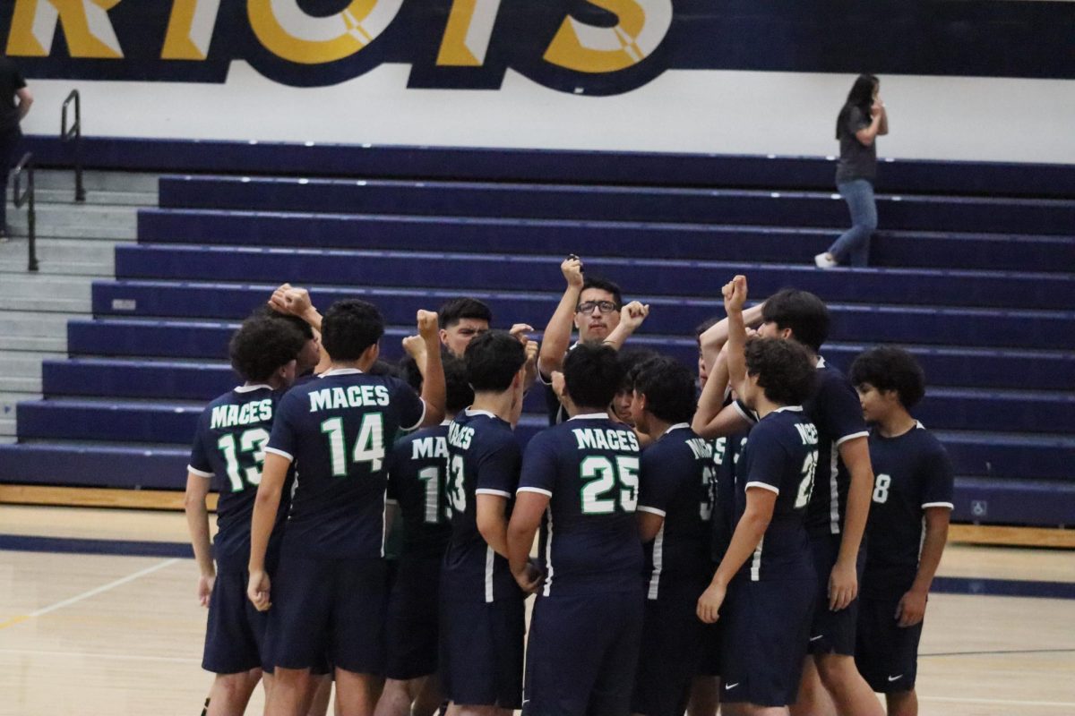 Boys Wolfpack Volleyball in a pre-game huddle preparing for their championship game against East Valley High School.