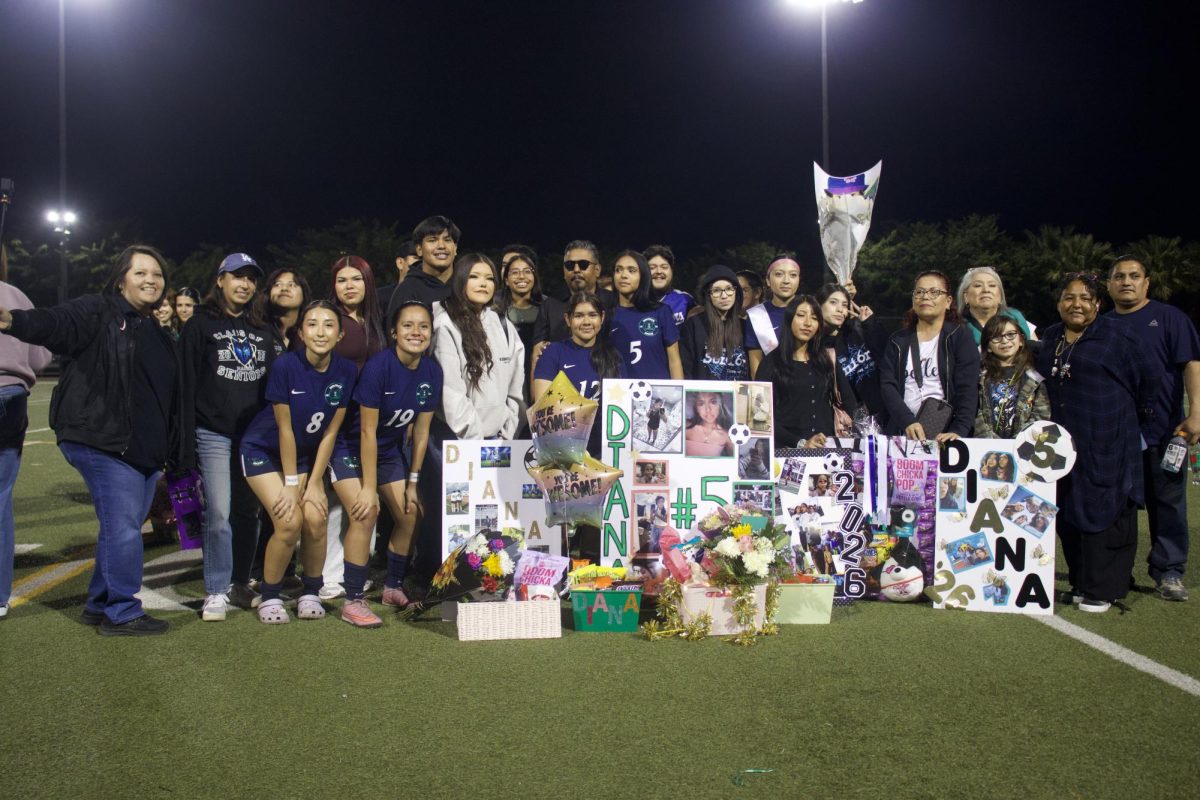 CELEBRATION - Maces Girls Soccer Seniors along with their parents pose with their poster during senior night.