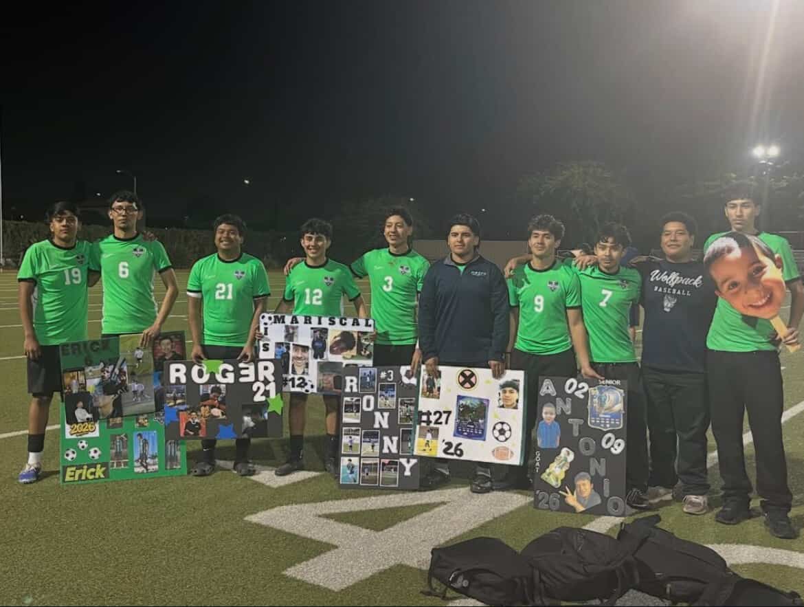 Maces boys soccer seniors pose with their posters during senior night after their final home game of the season.