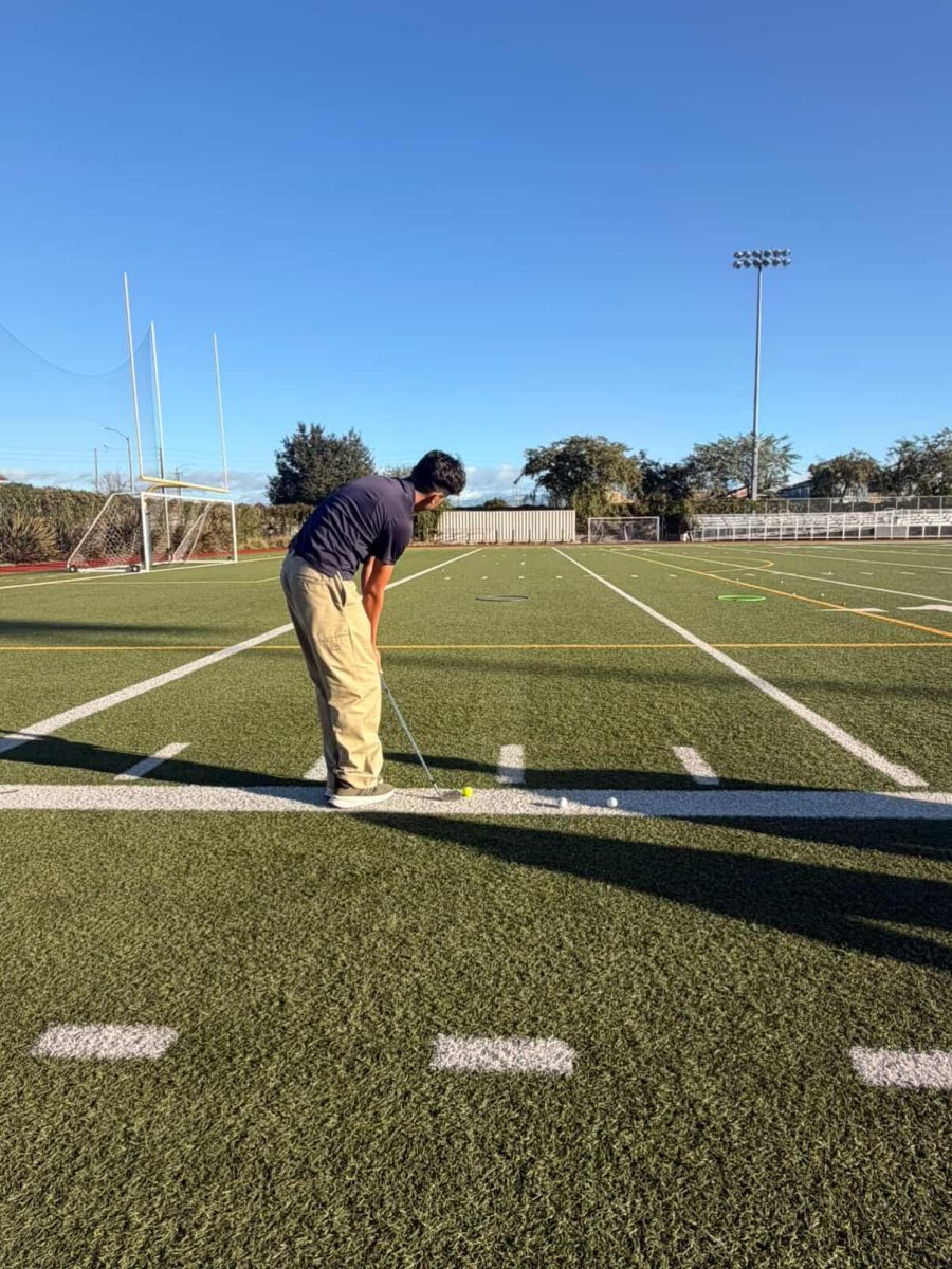 Player getting ready to hit his long distance swing at practice. 