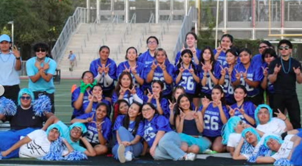 Seniors powderpuff team celebrates their win by closing out the game with strong school spirit.